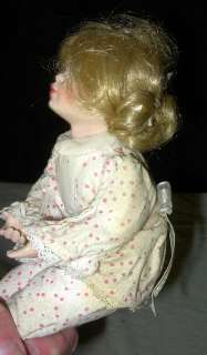   is a neat 1992 mbi artist signed porcelain girl doll the young girl