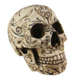 this wickedly awesome human skull figure statue is covered in celtic 