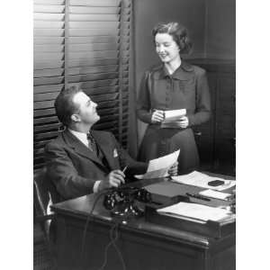  Secretary Talking To Man Seated at Desk Photographic 
