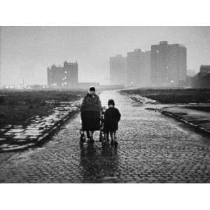 Mother and Children Walk Along Deserted Cobbled Street Photographic 