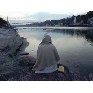 Hindu Pilgrim Meditates Along the Bank of the Ganges River Premium 
