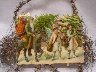 lovely antique paper and tinsel ornament. This looks to be Santa 
