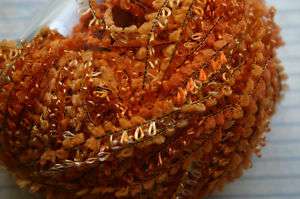 1sk ICE Boucle Yarn Loopy Tonal Orange on black thread  