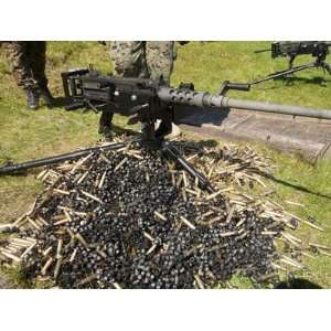  A .50 Caliber Browning Machine Gun with a Pile of Spent 