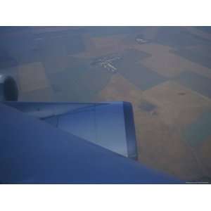  A View of Patchwork Fields and Jet Engines of a Plane in 